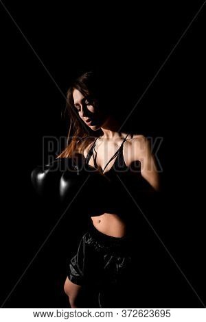 Female Boxer Training In The Dark Ring. Silhouette. Boxing Concept. Fighter Woman Fist Close Up. Sex