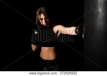 Female Boxer Training In The Dark Ring. Silhouette. Boxing Concept. Fighter Woman. Sexy Girl With Pe
