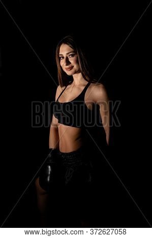 Female Boxer Training In The Dark Ring. Silhouette. Boxing Concept. Fighter Woman Fist Close Up. Sex