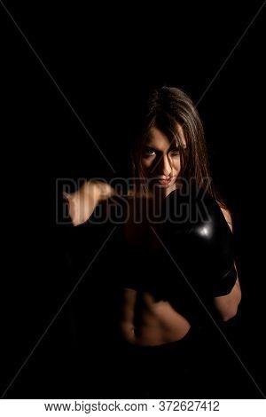 Female Boxer Training In The Dark Ring. Silhouette. Boxing Concept. Fighter Woman Fist Close Up. Sex