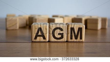 Concept Word 'agm' - Acronym Of Words 'annual General Meeting' On Cubes On A Beautiful Wooden Table.