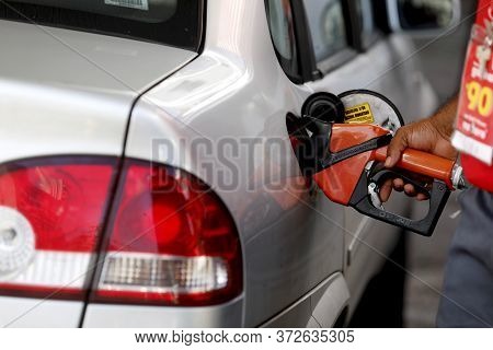 Salvador, Bahia / Brazil - August 20, 2019: Gas Station Attendant Is Seen Fueling A Vehicle At A Gas