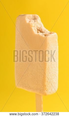 Milk Tea Flavor Popsicle With A Bite On Yellow Background