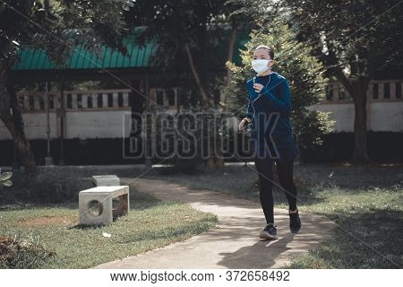 Portrait Of Asian Woman Workout Before Running At Village Park. Cheerful Runner Stretching And Warmi