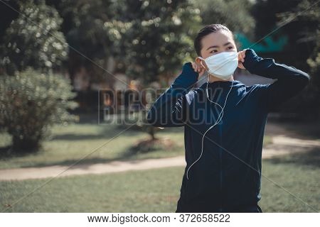 Portrait Of Asian Woman Workout Before Running At Village Park. Cheerful Runner Stretching And Warmi