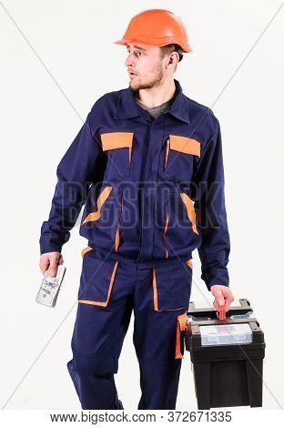 Construction And Rollback Concept. Man With Toolbox Walks, Holds Money.