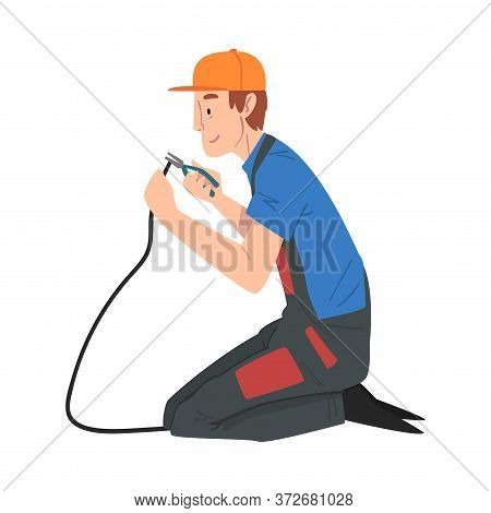 Male Electrician Engineer Sitting On His Knee Repairing Cable With Pliers, Electricity Maintenance S