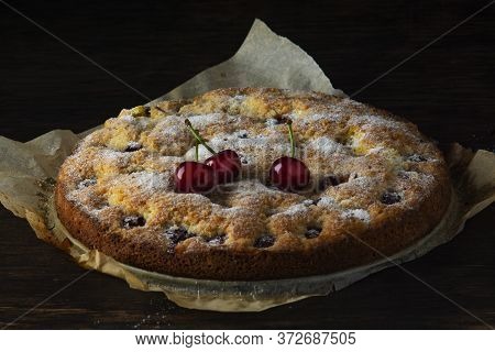 Cherry Pie On An Old Dark Wooden Table.