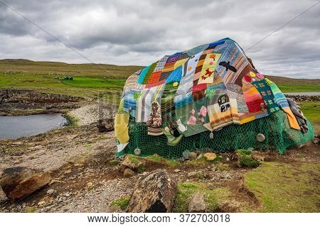 Eldgos And Frumskogur The Boulder Covered With Clothes In Sandoy