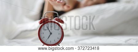 Girl Lies On Bed And Turns Off Alarm In Morning. Persistent Lack Sleep Destroys Motivation. Sleepy P