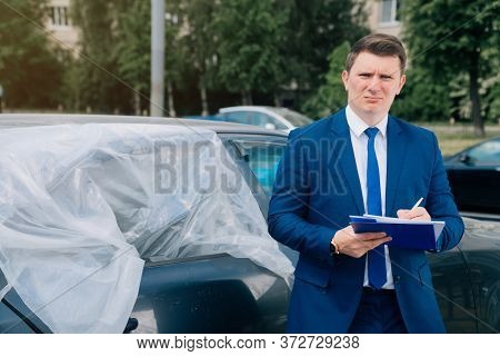 A Man Writes In A Tablet Next To The Car. An Accident On The Road, The Airbag Didnt Work.