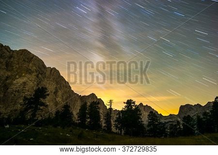 Star Trails Night Sky At Twilight Hour. Julian Alps, Triglav National Park, Slovenia, Mountain View 