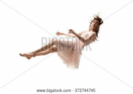 Mid-air Beauty Cought In Moment. Full Length Shot Of Attractive Young Woman Hovering In Air And Keep