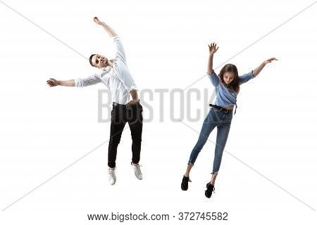 Mid-air Beauty Cought In Moment. Full Length Shot Of Attractive Young Woman And Man Hovering In Air 