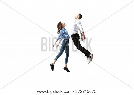 Mid-air Beauty Cought In Moment. Full Length Shot Of Attractive Young Woman And Man Hovering In Air 