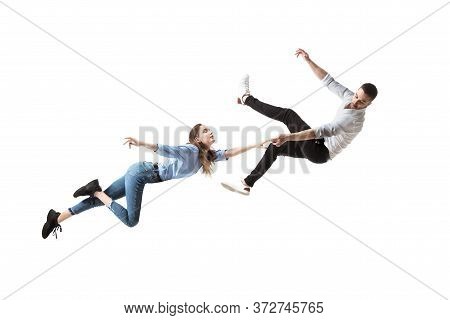 Mid-air Beauty Cought In Moment. Full Length Shot Of Attractive Young Woman And Man Hovering In Air 