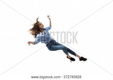 Mid-air Beauty Cought In Moment. Full Length Shot Of Attractive Young Woman Hovering In Air And Keep