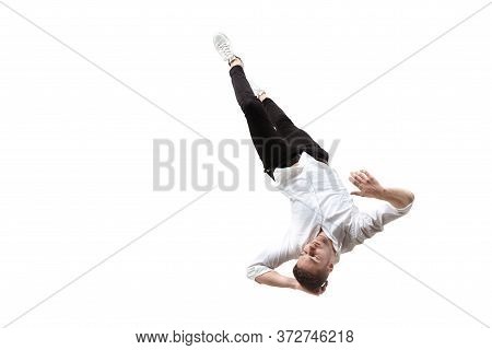 Mid-air Beauty Cought In Moment. Full Length Shot Of Young Man Hovering In Air And Keeping Eyes Clos