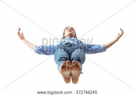 Mid-air Beauty Cought In Moment. Full Length Shot Of Attractive Young Woman Hovering In Air And Keep