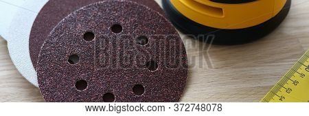 Close-up Of Sander Machine With Replacement Discs On Table. Grinding Equipment For Renovation And Co