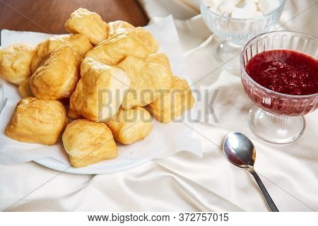 Nationally Kazakh Dish Baursaks Lie On A White Plate With A Cup Of Tea With Milk, Close-up