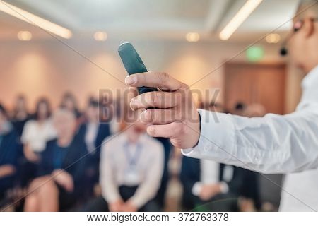 Man Hand Holding Laser Pointer. Male Speaker In Suit Giving A Talk At Business Meeting, Economic For