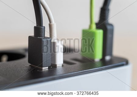Modern Convenient Multi-port Usb Charger For Devices. Close-up Of Multi-colored Cables In A Power Ou
