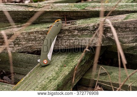 Folding Knife In The Folded Position. Blade Of A Knife Hidden In The Handle.