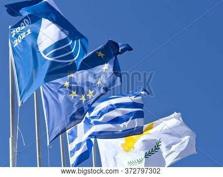 Blue Flag, European Union Flag And National Flags Of Cyprus And Greece Waving In Front Of Bright Blu