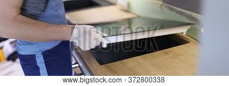 Close-up Of Professional Handyman Setting Cookstove. Male In Protective White Gloves On Kitchen. Mov