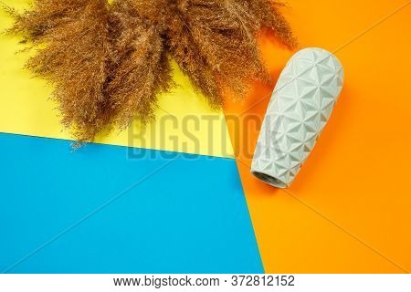 A Minimalistic Composition Of A Light Turquoise Ceramic Vase, Lies An Empty Vase On A Colored Backgr