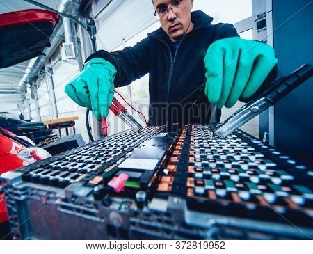 Charging The Batteries Of The Elecric Motor. Disassembling The Battery