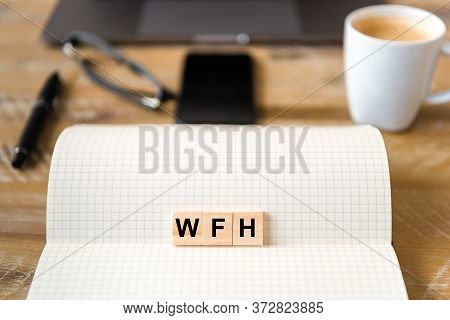 Closeup On Notebook Over Wood Table Background, Focus On Wooden Blocks With Letters Making Wfh Worki