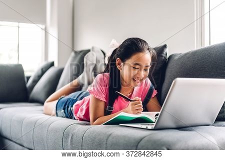 School Kid Little Girl Learning And Looking At Laptop Computer Making Homework Studying Knowledge Wi