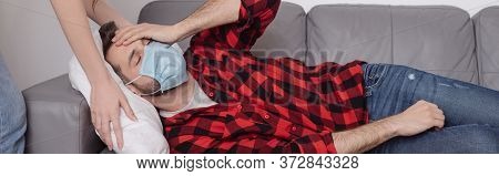 Cropped View Of Woman Touching Pillow While Sick Boyfriend Lying On Sofa And Holding Hand On