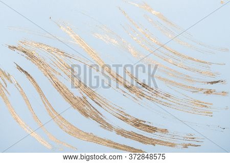 Abstract Gold Potal Brush Strokes On Blue Pastel Paper Background Or Texture