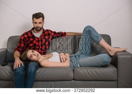 Young Couple On Sofa At Home During Quarantine