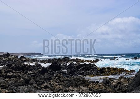 Arikok Natural Park On The Island Of Aruba In The Caribbean Sea With Deserts And Ocean Waves On The
