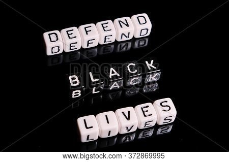 Defend Black Lives Text On A Black Background. Blm In Support Of African Americans People