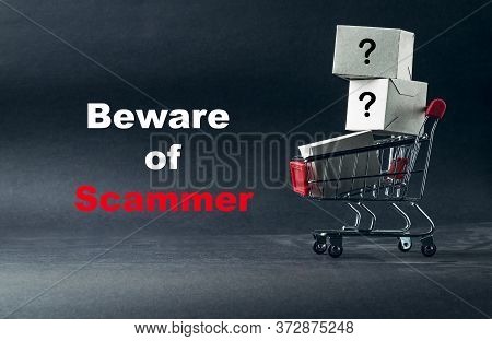 Words Beware Of Scammer On Dark Background With Shopping Cart. Business, Copy Space And Online Shopp