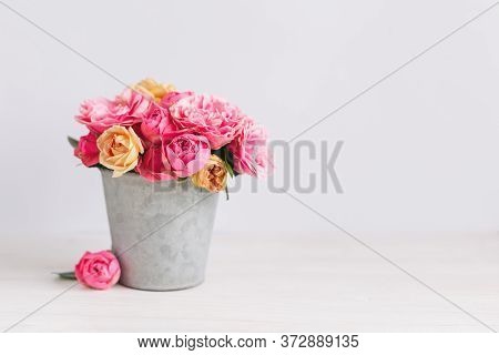 Romantic Bouquet Of Pink And Yelloow Roses In A Vintage Pot On A White Background.  Place For Text.