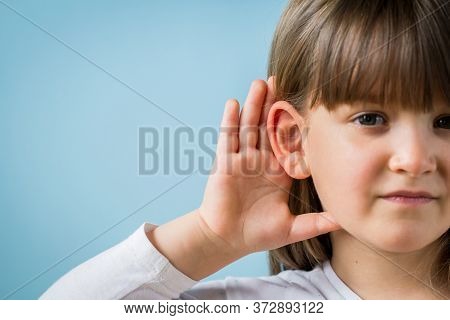 Child With Hearing Problem On Blue Background. Hearing Loss In Childhood, Symptoms And Treatment Con