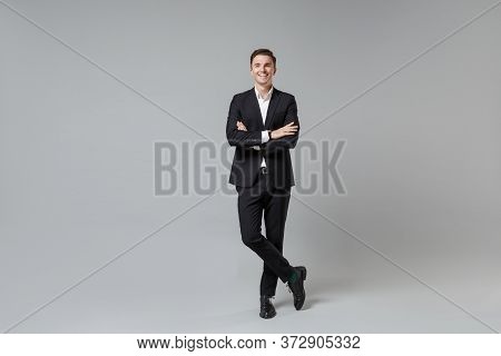 Cheerful Young Business Man In Classic Black Suit Shirt Posing Isolated On Grey Wall Background Stud