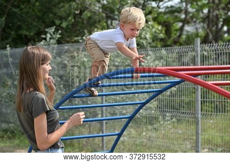 A Boy With Cochlear Implants Playing In Summer Park