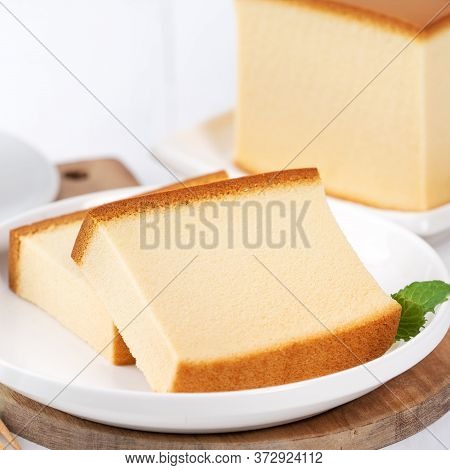 Castella (kasutera) - Beautiful Delicious Japanese Sliced Sponge Cake Food On White Plate Over Rusti