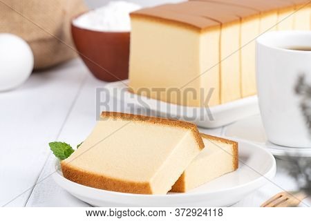 Castella (kasutera) - Beautiful Delicious Japanese Sliced Sponge Cake Food On White Plate Over Rusti