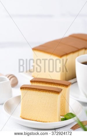 Castella (kasutera) - Beautiful Delicious Japanese Sliced Sponge Cake Food On White Plate Over Rusti