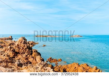a view of the rock formations in La Tonnara, on the Southern coast of Corsica, France, with the calm Mediterranean sea in the background