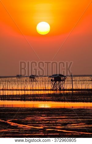 Beautiful Landscape View Of Sunset Time Going Down To In The Sea With Foreground Of Beach In Tropica