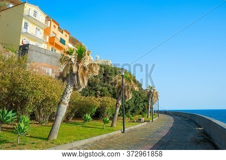 Couple On Empty Promanade At Jardim Do Mar Village. Madeira Island, Portugal